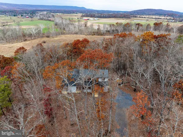 a view of a hallway with wooden floor and a window