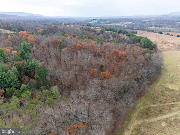 a kitchen with kitchen island granite countertop wooden floors a stove and a sink