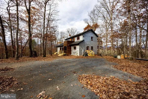 a view of a house with a patio and a yard
