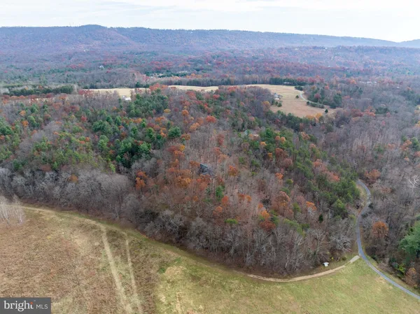 a view of a living room and kitchen with hardwood floor