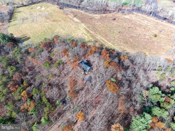 a view of a porch with a refrigerator and a table