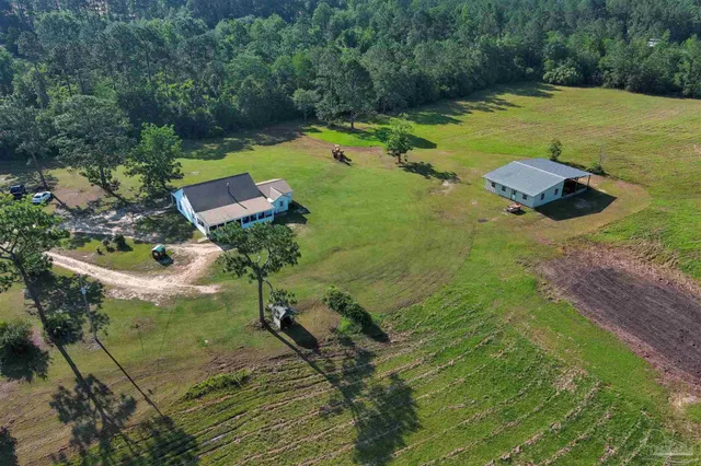 an aerial view of a house with outdoor space