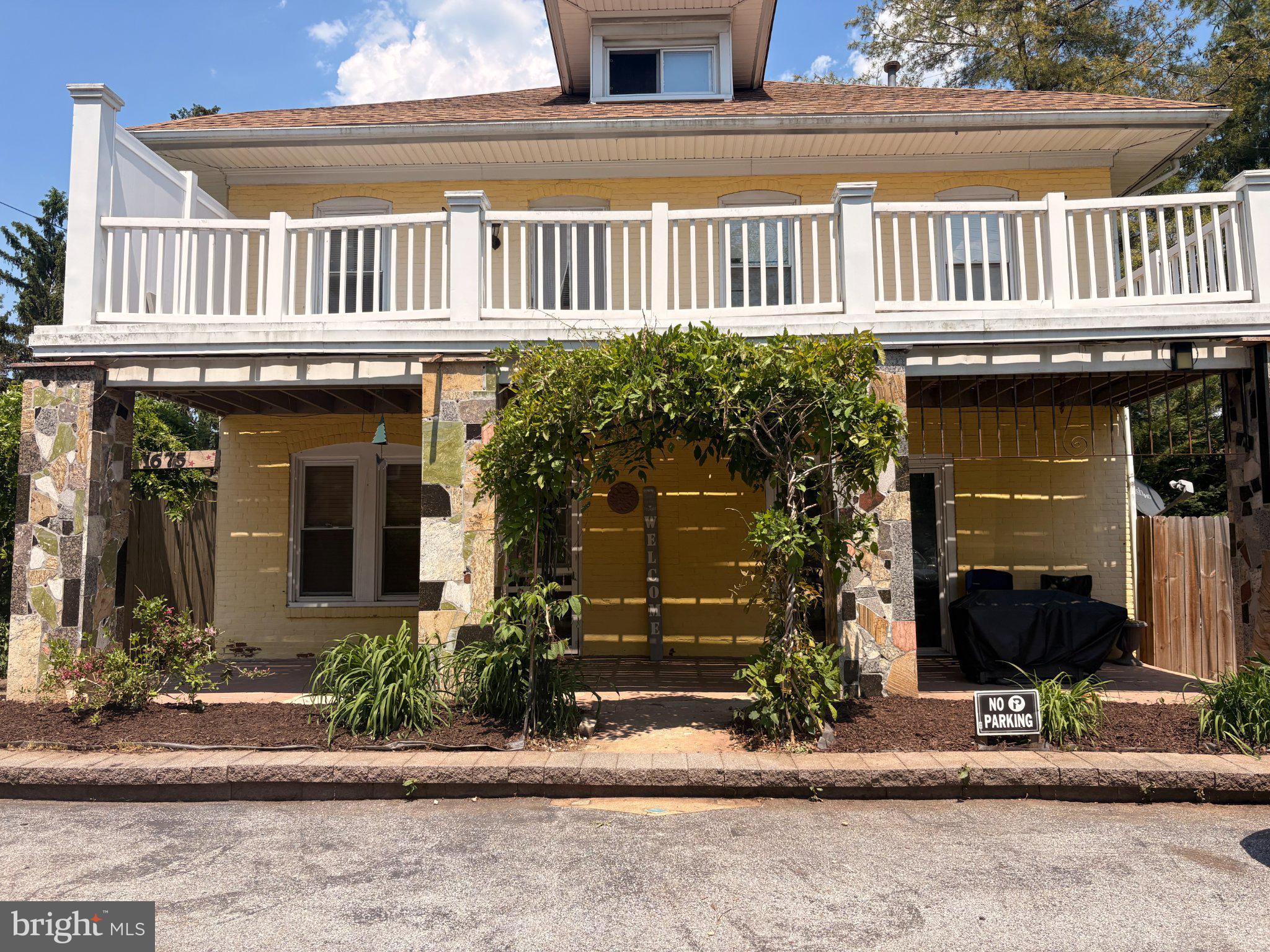 Charming yellow home with inviting porch.