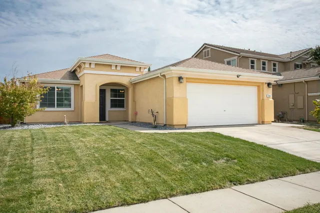 a front view of a house with a garden