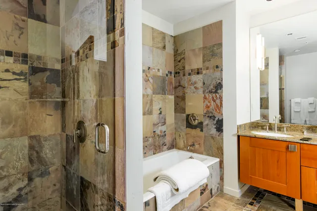 a bathroom with a sink toilet tub and shower