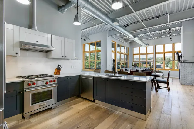 a kitchen with stainless steel appliances a stove a sink dishwasher and a microwave oven with cabinets