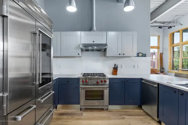 a kitchen with a stove and a refrigerator