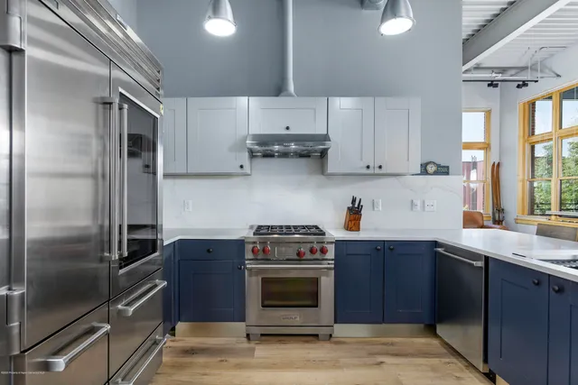 a kitchen with a stove and a refrigerator