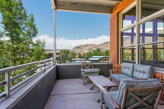 a view of balcony with outdoor seating and city view