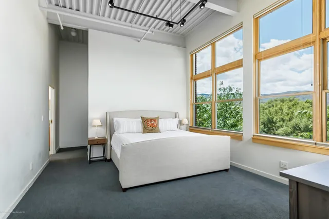 a bed sitting in a room next to a window