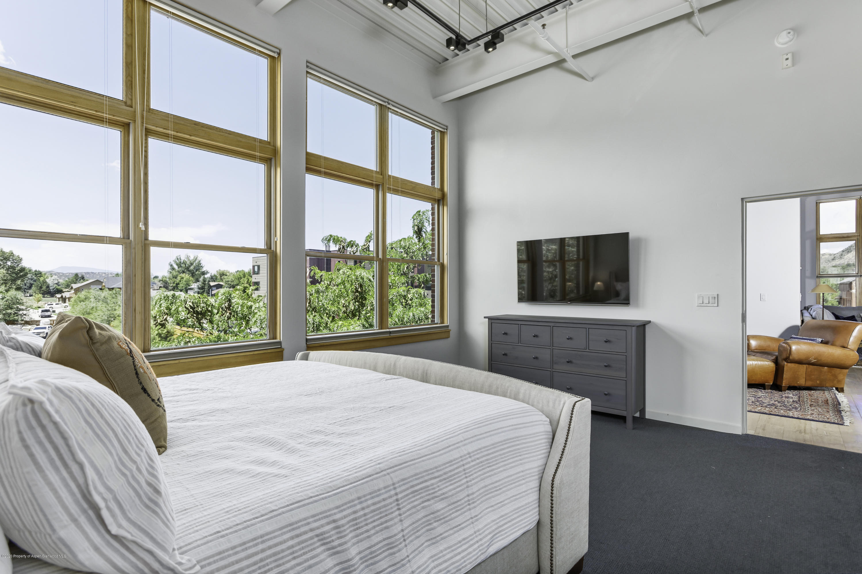 231 Robinson Street, Unit R212 Basalt, CO 81621 - Photo 9 of 14 a bedroom with a bed and a flat screen tv