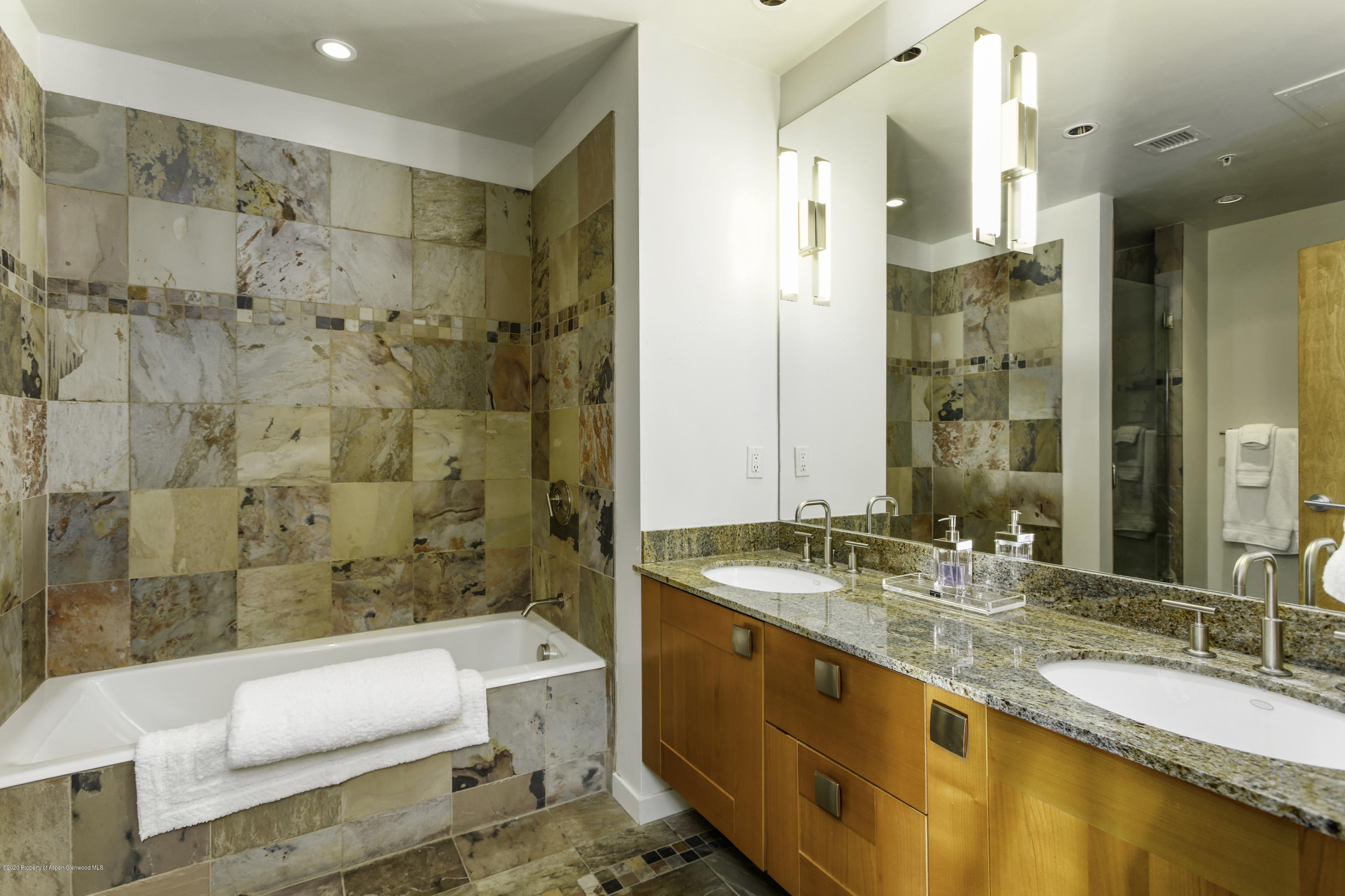 231 Robinson Street, Unit R212 Basalt, CO 81621 - Photo 10 of 14 a bathroom with a granite countertop tub sink and double vanity