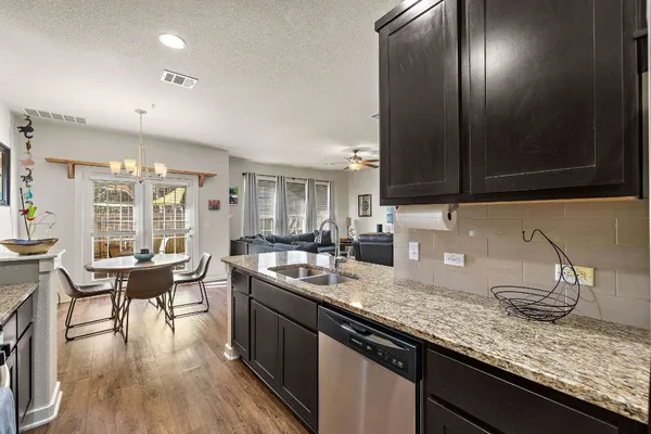 a kitchen with granite countertop lots of counter top space and furniture