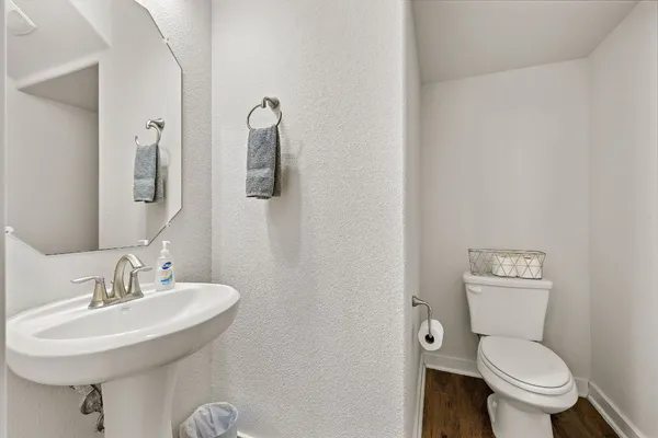 a bathroom with a toilet sink and mirror