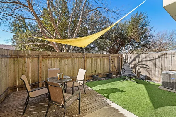 a patio with a table and chairs