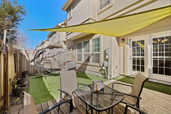 a view of a house with backyard and sitting area
