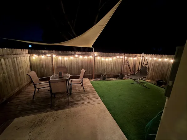 a view of a porch with chairs and backyard