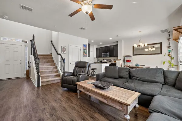a living room with furniture and a view of kitchen