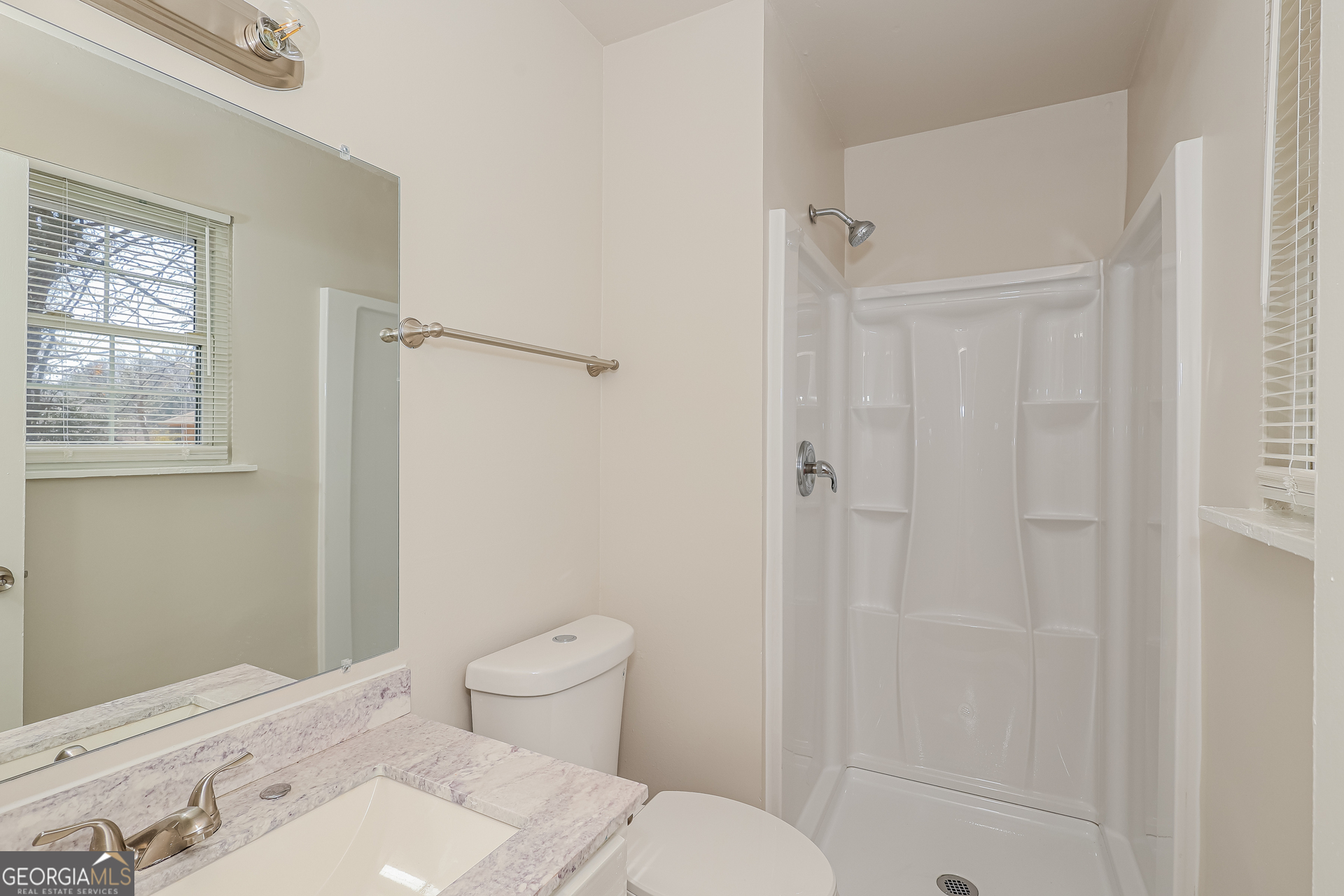 295 Adena Lane West South Fulton, GA 30349 - Photo 11 of 16 a bathroom with a sink a toilet and shower