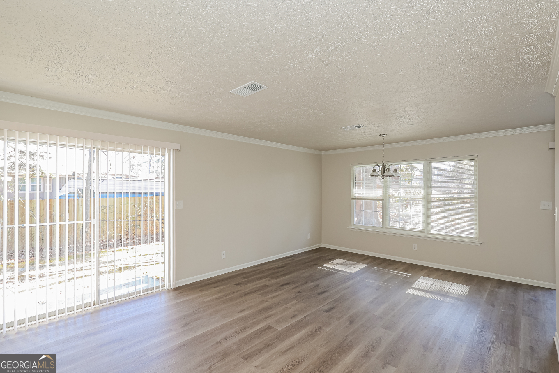 295 Adena Lane West South Fulton, GA 30349 - Photo 3 of 16 an empty room with wooden floor and windows