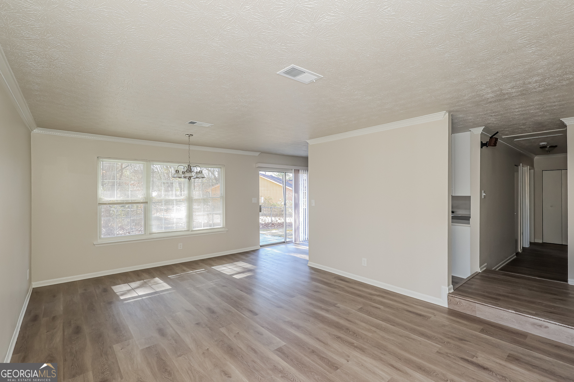 295 Adena Lane West South Fulton, GA 30349 - Photo 4 of 16 an empty room with wooden floor and windows