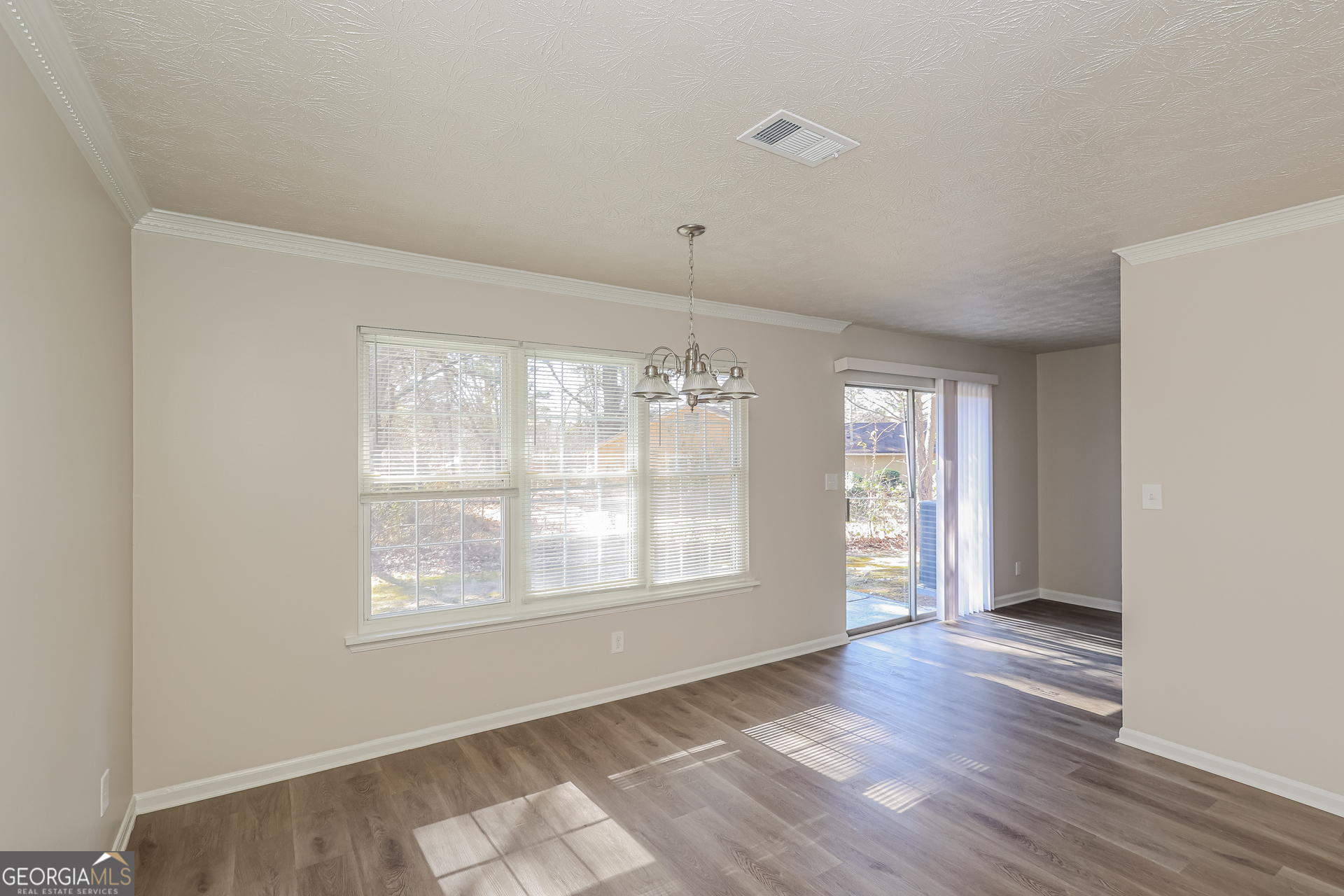 295 Adena Lane West South Fulton, GA 30349 - Photo 6 of 16 a view of an empty room with wooden floor and a window