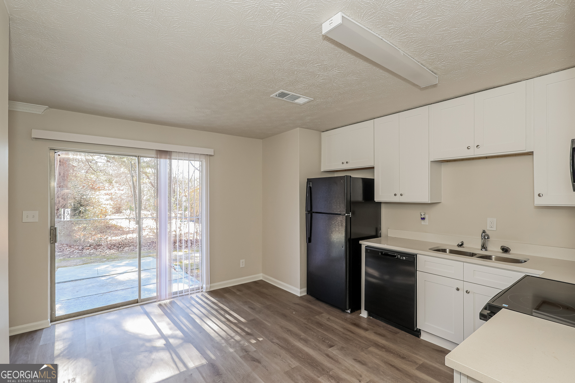 295 Adena Lane West South Fulton, GA 30349 - Photo 8 of 16 a kitchen with a refrigerator and a sink