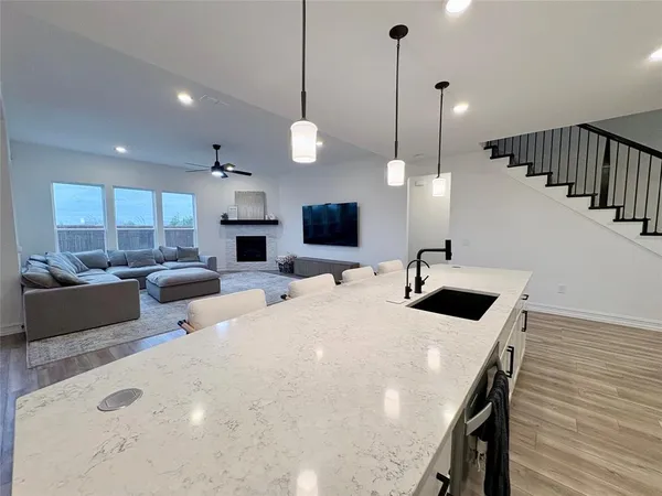 a large kitchen with a table and chairs