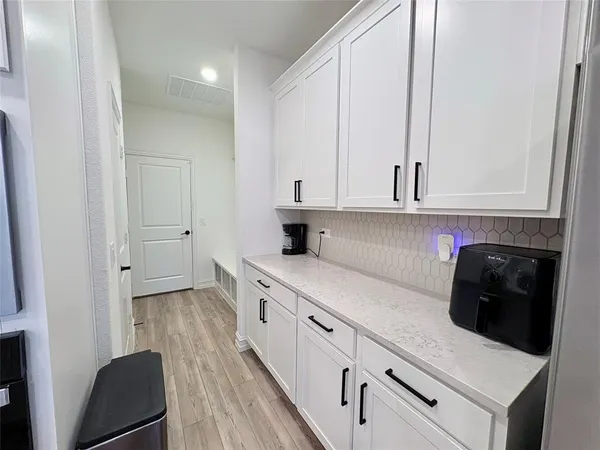 a kitchen with stainless steel appliances white cabinets and a sink