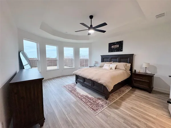 a bedroom with a large bed and a window