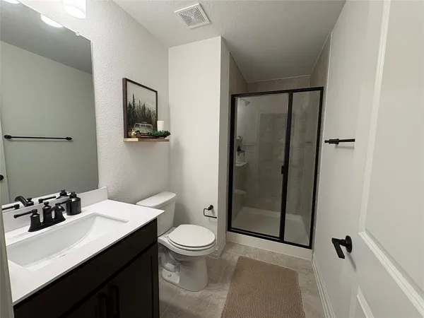 a view of an empty room with a ceiling fan