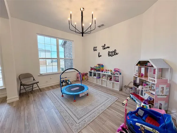 a living room with lots of furniture and a book shelf
