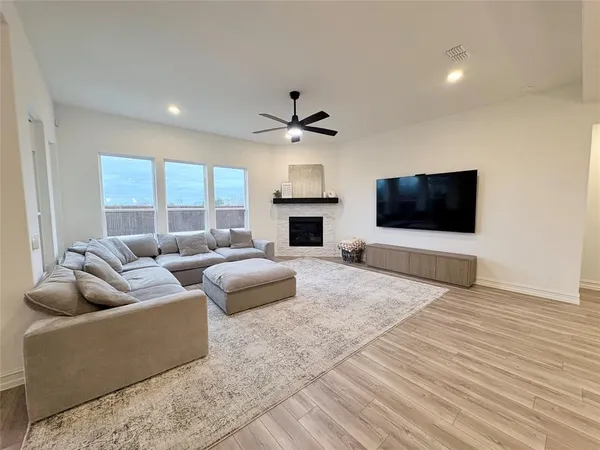 a living room with furniture fireplace and window