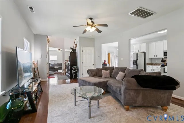 a living room with furniture and a chandelier