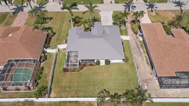 an aerial view of a house with a yard