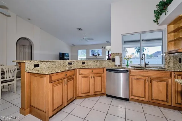 a kitchen with granite countertop a sink and cabinets
