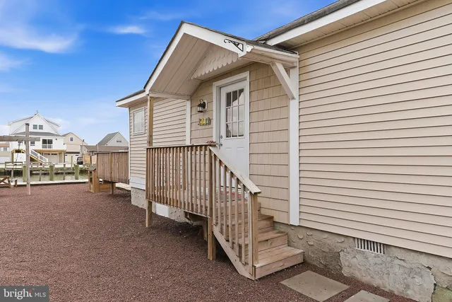 a kitchen with a table chairs refrigerator and cabinets