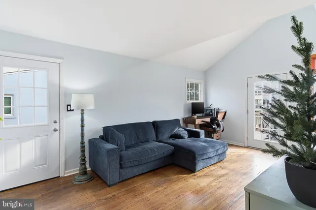a kitchen with a table chairs refrigerator and microwave