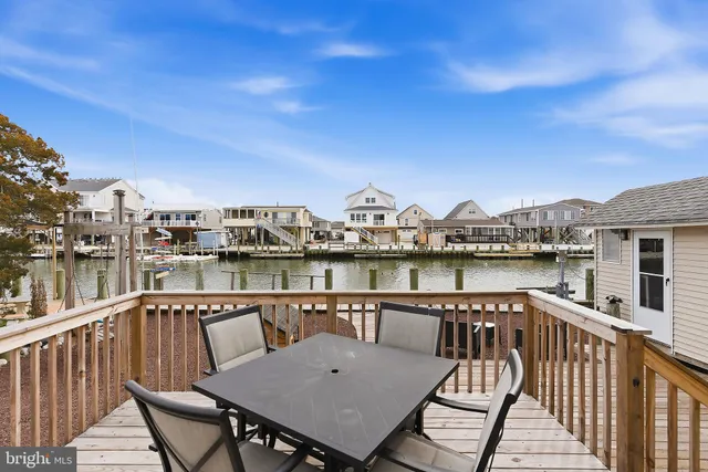 a kitchen with stainless steel appliances kitchen island granite countertop a refrigerator and a stove top oven