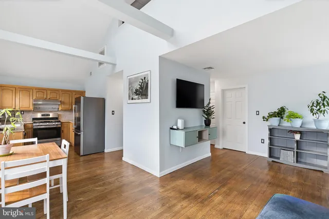 a kitchen with granite countertop a refrigerator stove and microwave