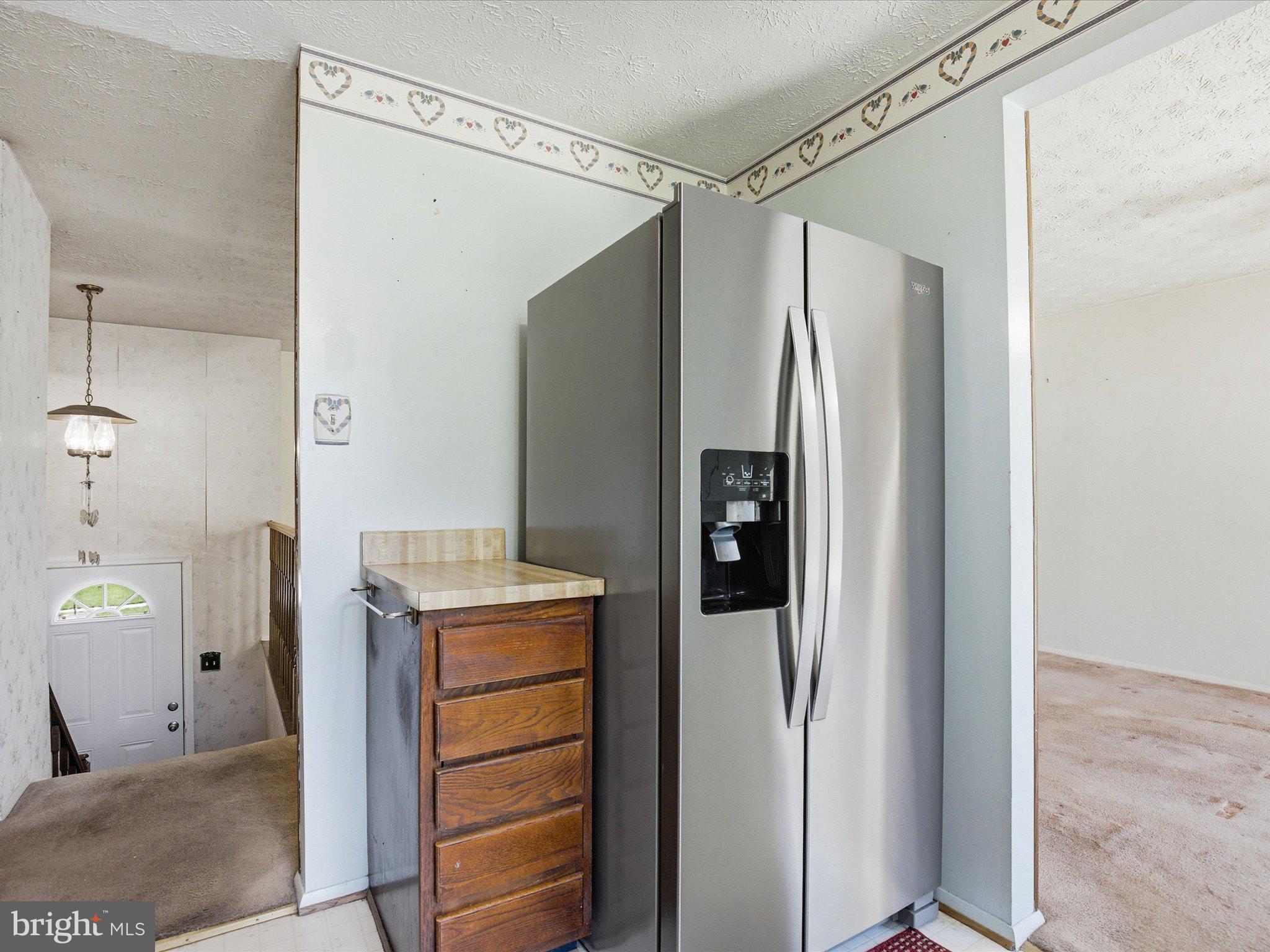 6314 West Vein Road Bowie, MD 20720 - Photo 12 of 28 a kitchen with a refrigerator and countertop