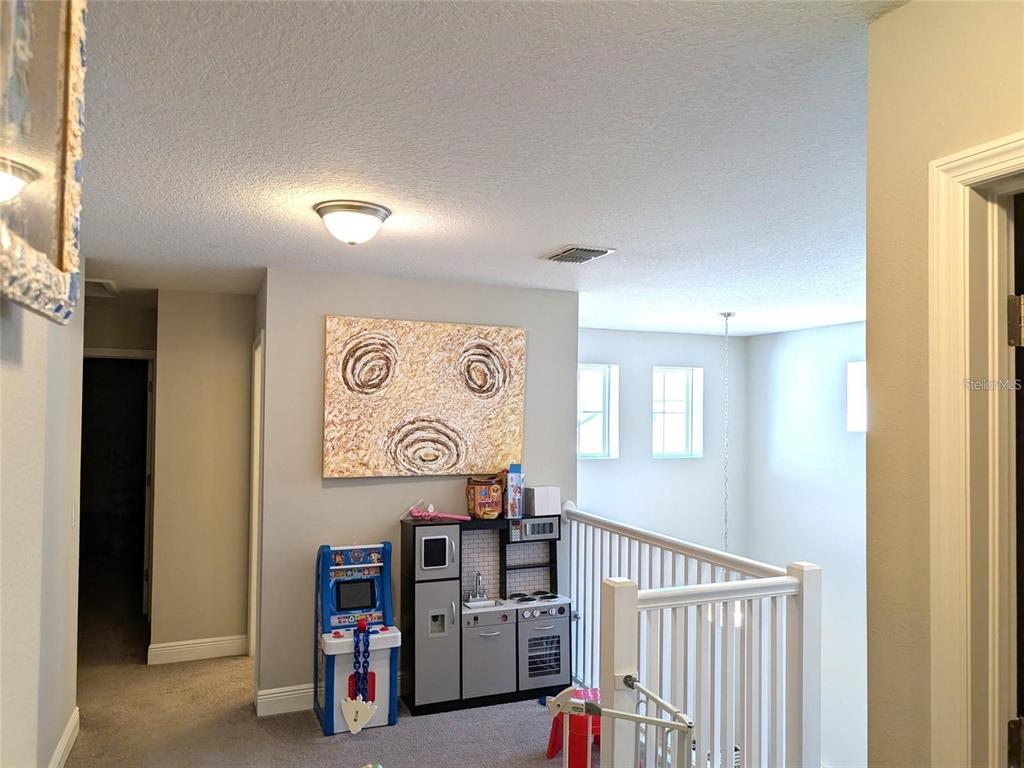 7545 Pool Compass Loop Wesley Chapel, FL 33545 - Photo 11 of 25 a view of a hallway with seating area