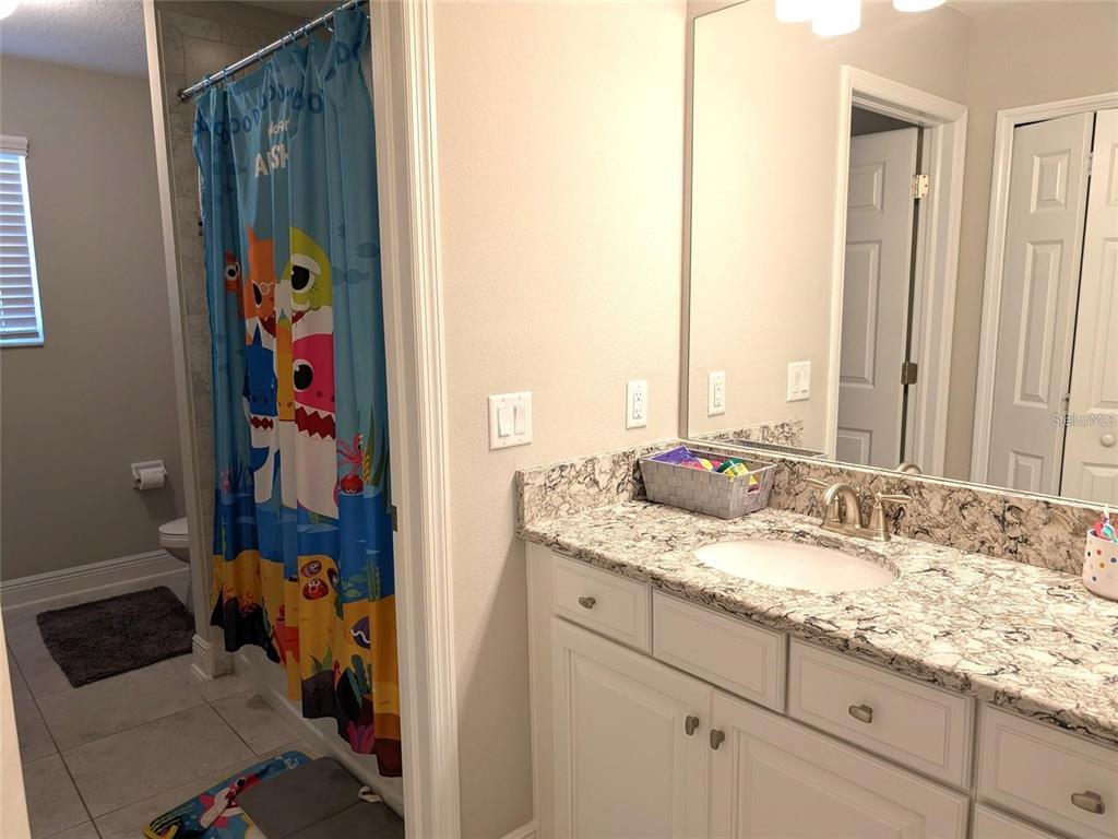 7545 Pool Compass Loop Wesley Chapel, FL 33545 - Photo 16 of 25 a en suite bathroom with a sink mirror and vanity