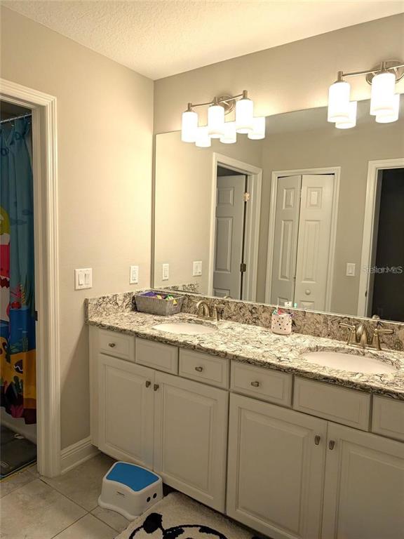 7545 Pool Compass Loop Wesley Chapel, FL 33545 - Photo 17 of 25 a bathroom with a sink and a mirror