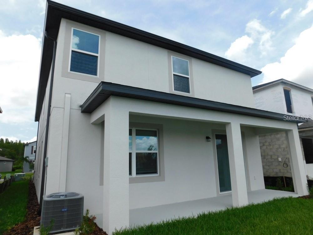 7545 Pool Compass Loop Wesley Chapel, FL 33545 - Photo 21 of 25 a house with a yard in front of it