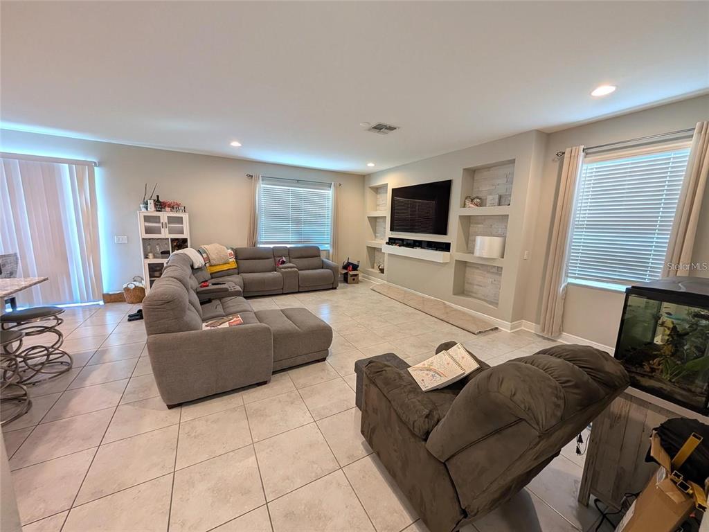 7545 Pool Compass Loop Wesley Chapel, FL 33545 - Photo 4 of 25 a living room with furniture and a flat screen tv