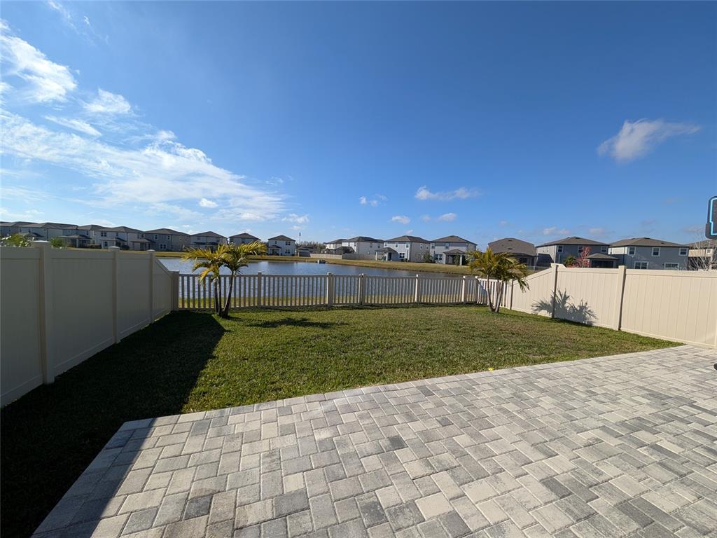 7545 Pool Compass Loop Wesley Chapel, FL 33545 - Photo 6 of 25 a view of a yard with an house and trees in the background