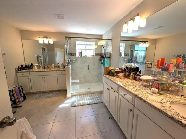 a large kitchen with a sink and cabinets