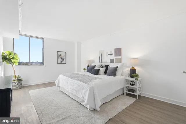 a bedroom with a bed and a potted plant