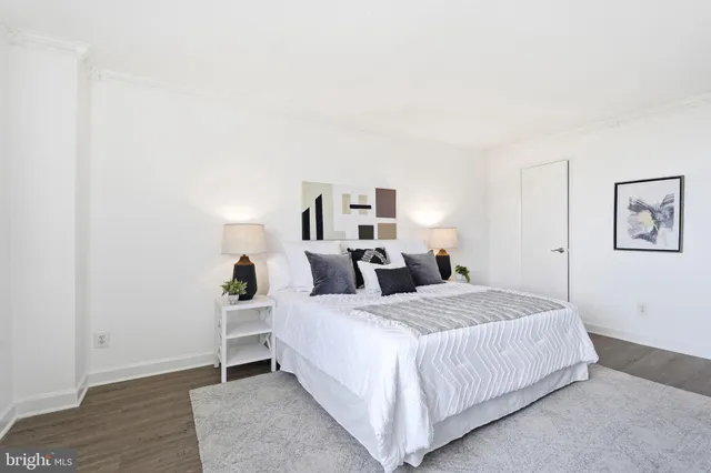 a bedroom with a bed and a night stand